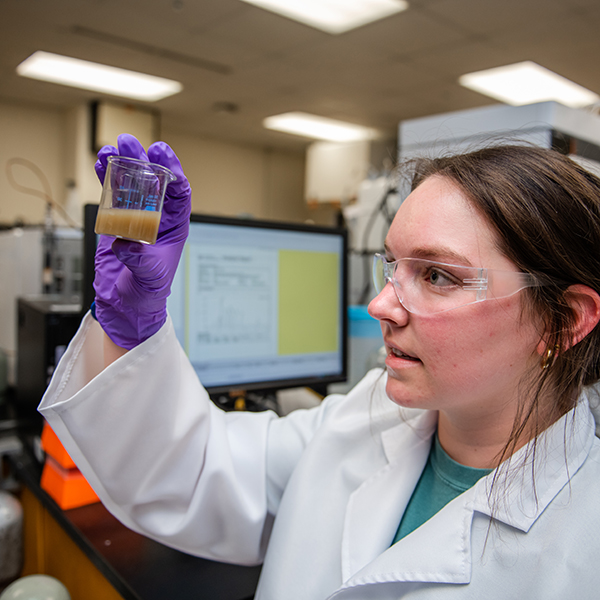 Student inspects liquid in a small beaker